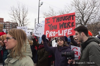 Young woman holding up sign I thought you were pro-life